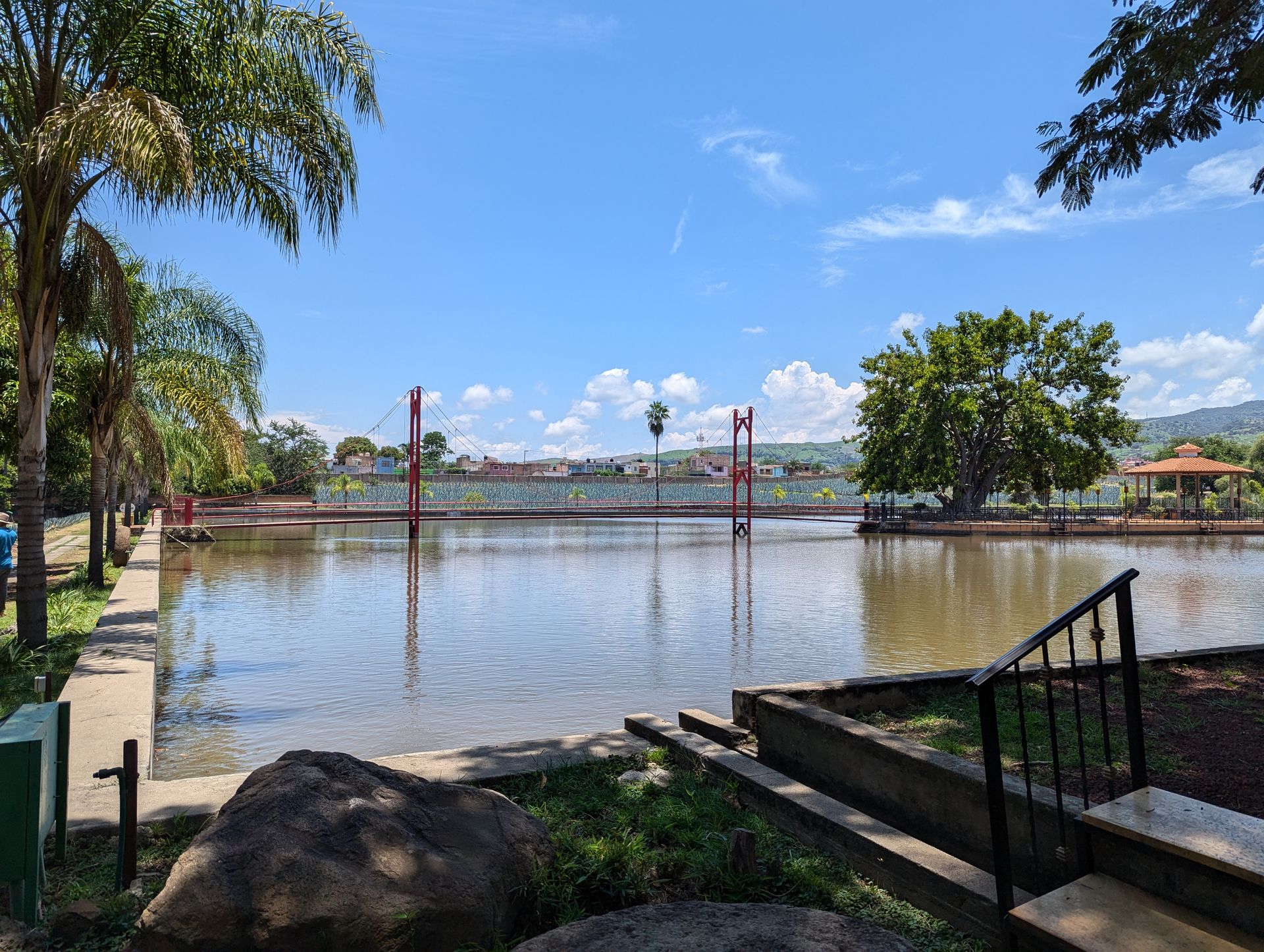 Red bridge over pond with gazebo
